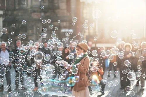 lady surrounded by bubbles in a magic setting